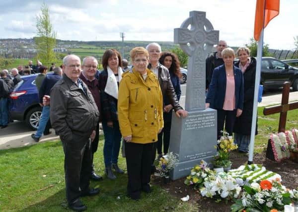 Family members and friends of Dale Moore gather at his grave side after the unveiling of a new headstone. Included is Sinn Fein MEP, Martina Anderson, far right.