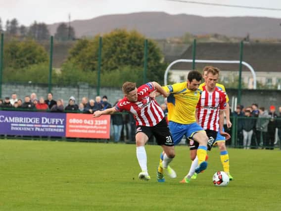 Gareth Harkin, Finn Harps and Mikhail Kennedy, Derry City battle for possession during Friday night's NW derby at Maginn Park.