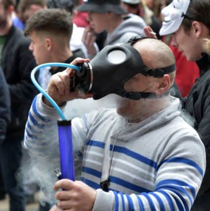 A man inhaling at the LegenDerry Cannabis Club 4/20 cannabis smoke out protest, in Guildhall Square, in a show of solidarity with cannabis consumers worldwide. Herbal & Cannabis Resin are currently illegal Class B drugs in Northern Ireland. DER1617GS007
