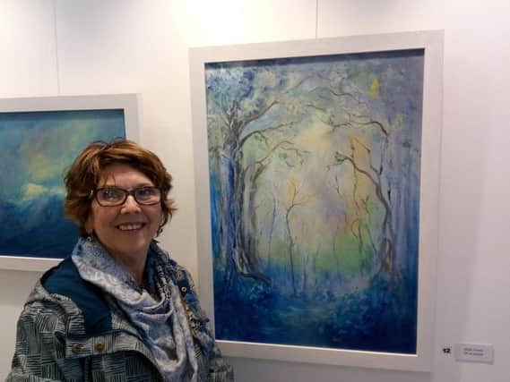 Maryellen Bell pictured with one of her striking paintings from the 'To Reach Oceans of Bluebells'