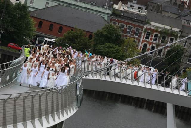 A section of the brides make their way across the Peace Bridge on Saturday in 2014.