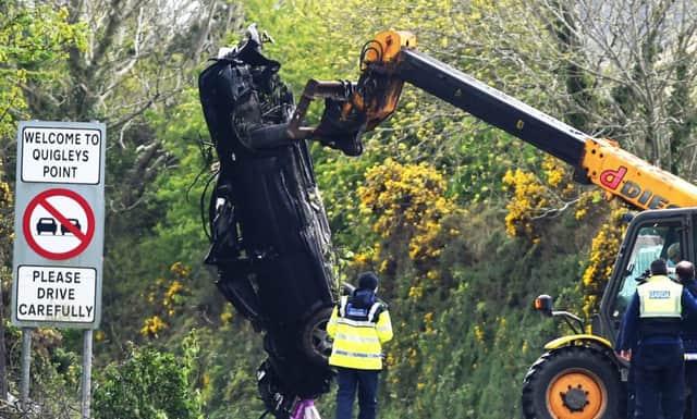 A car is removed from the scene of Saturday's early morning crash in Inishowen in which two teenagers were killed.