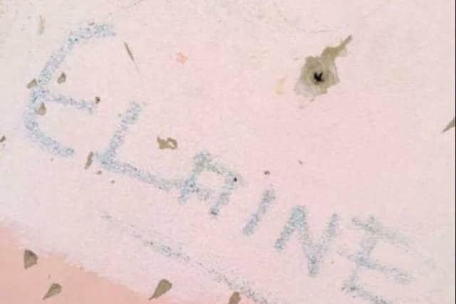The etching of Elaine's name in her old bedroom.