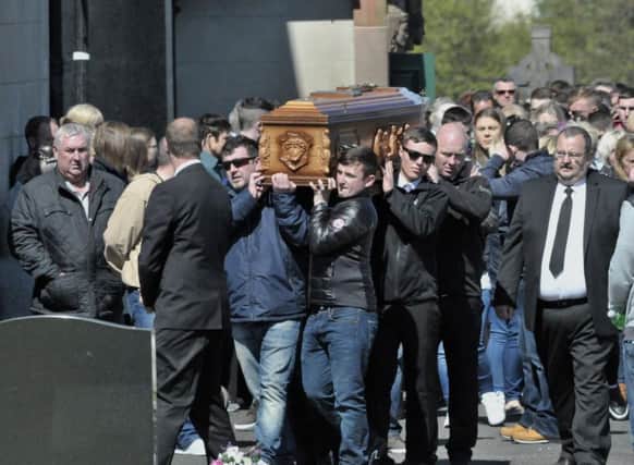 Mourners carry the coffin of 18 year-old Nathan Farrell, from St Marys Church Cockhill, following Requiem Mass yesterday, for burial in the nearby Cockhill cemetery. DER1817GS032