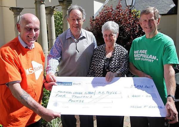Nelson McGonagle (second left) presents a cheque totalling Â£4000 to terry McNamee from  MS (Foyle) and Malcolm Stuart from Macmillan Cancer at Roe Park Hotel. Also pictured is Margaret McGonagle.