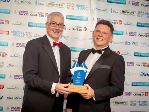 Eugene Kearney, Bank of Ireland, principal sponsor presenting the North West Business of the Year award to Robbie O'Brien, MetaCompliance at the North West Business Awards at the Everglades Hotel