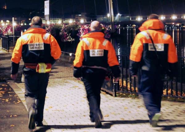 Volunteers from Foyle Search and Rescue patrolling along the river at night.