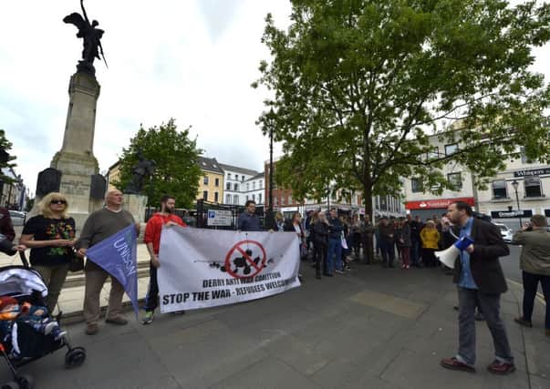 People gather at the War Memorial in the Diamond, on Tuesday evening, for a solidarity vigil with Manchester following the suicide bombing at the Manchester arena on Monday night last. The vigil was organised by the Derry Anti War Coalition. DER2117GS006