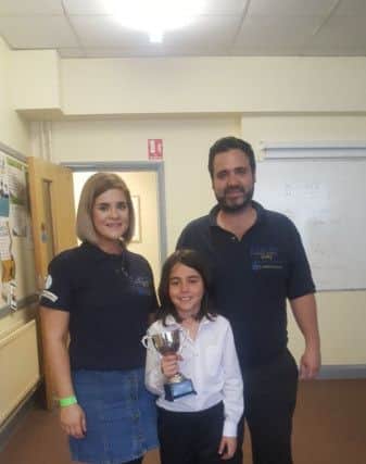 Helen McGonigal and Eoin O'Hara congratulate Valentino for winning the Jimmy O'Hara Memorial Cup for tin whistle at the County Derry Fleadh held in Limavady at the weekend. Helen O'Hara,  Branch Secretary of Jimmy O'Hara CCE, said people sang, danced, told stories and played music all weekend long.