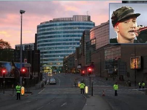 A photograph taken moments after the Manchester terror attack. Inset: Eminem.