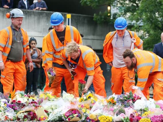 People lay flowers near London Bridge following Saturday's terrorist attack. Photo: Isabel Infantes/PA Wire