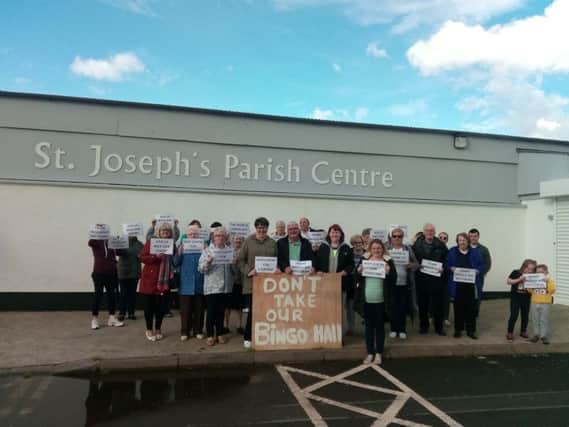 Protesters gathered outside Galliagh Parish Centre on Saturday evening.