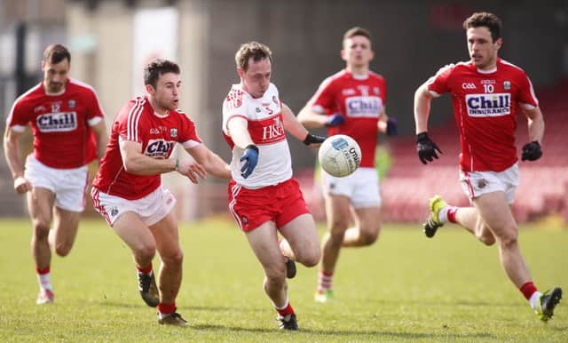 Derry's Neil Forester takes on Cork's Stephen Cronin, Kevin O'Driscoll and John O'Rourke during the league.

( Photo Lorcan Doherty / Presseye.com)