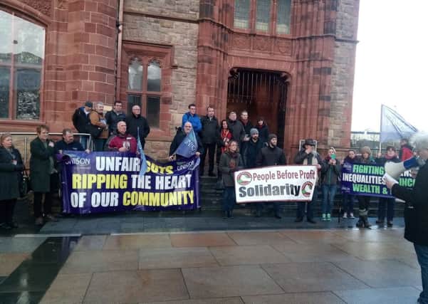 Local Councillors and protesters take a stance against the threat to Foyle Haven's services earlier this year outside the Guildhall.