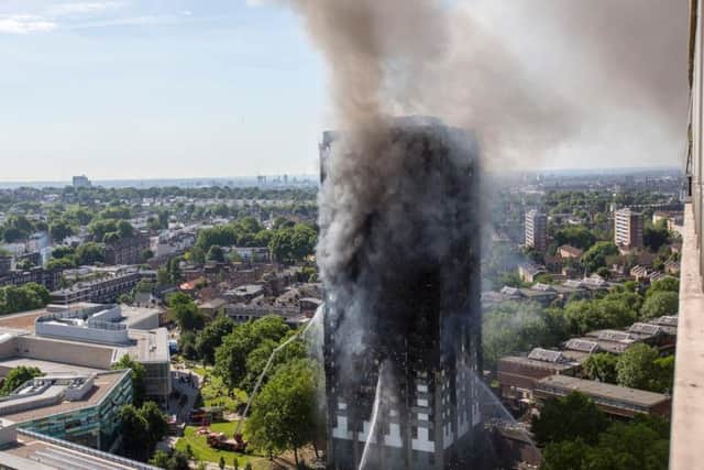 Smoke billows from a fire that has engulfed the 24-storey Grenfell Tower in west London.