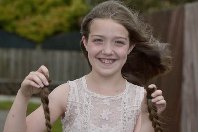 Ten-year-old Ellie Doherty pictured after she had 12 of her hair cut off to be made into wigs for chemotherapy patients.  DER2517GS077