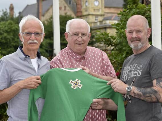 Kevin Knight (right) returning Tony ODohertys N. Ireland international jersey in the company of Lornie McDevitt (centre) who presented it to the Englishman four and a half decades ago.
