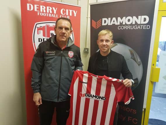 Nicky Low, pictured with Derry City manager, Kenny Shiels when he signed his initial six month loan deal, believes he has 'unfinished business' at the club.