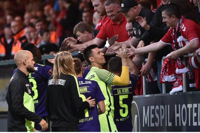 Derry City supporters congratulate Midtjylland players at the end of the Europa League First Qualifying Round Second Leg match between Derry City and Midtjylland at The Showgrounds in Sligo.