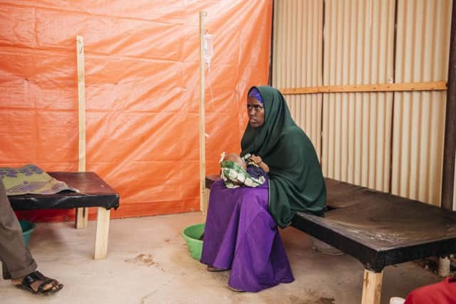 Antal Abdi Haji has her severely dehydrated son, Rahma, examined by personnel at Akara CTC. Photo: Amunga Eshuchi.