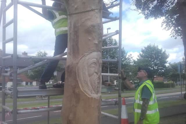 The artists working on the tree in the Belmont area.