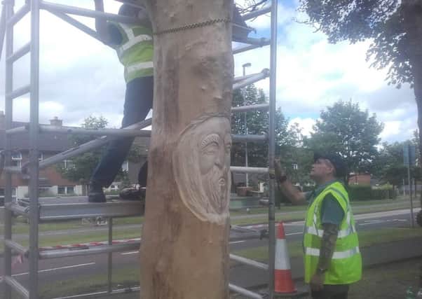 The artists working on the tree in the Belmont area.