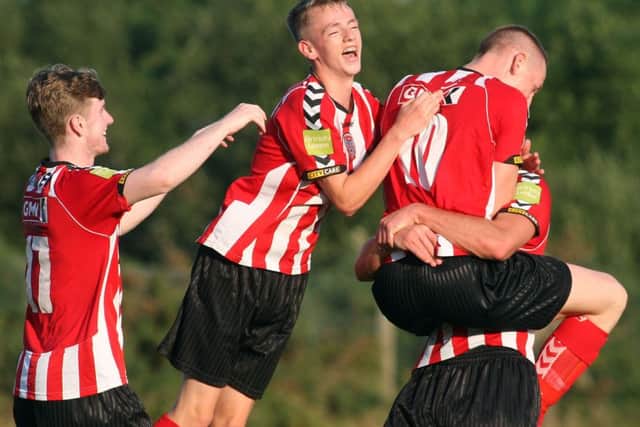 Derry City youngsters Chris Flanagan, Ciaron Harkin (jumping) and Ronan Curtis (10) celebrate the strikers goal against Altrincham, in the 2014 Hughes Insurance Foyle Cup U19 final.