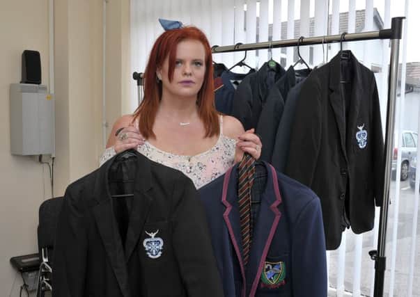 Vanessa Craig pictured in the Shantallow Community Collective, Racecourse Road, this week with some of the donations to her School Uniform Recycling initiative. DER3017GS037