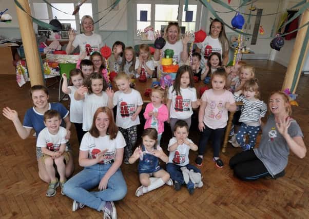 Pauline Ross, founder of the Playhouse, celebrating the theatres 25th birthday with children and staff earlier this week.  DER3017GS038