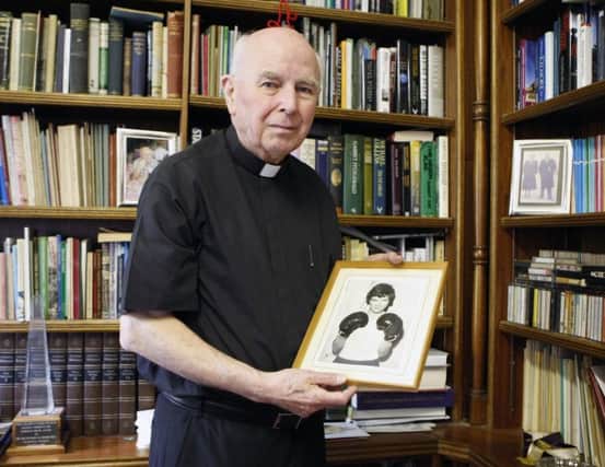 Bishop Edward Daly holds a portrait of Jackie Duddy (Niall Carson/PA Wire)
