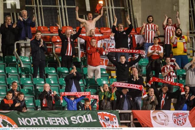 Derry City supporters celebrate after Barry McNamee finds the net from just inside the Shamrock Rovers half at Tallaght Stadium.
