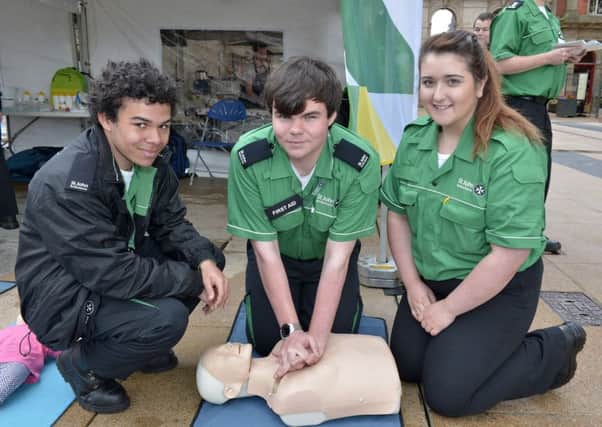 St Johns Ambulance volunteers Tyrone Jones, Nigel Brinner and Lucy Kane demonstrate CPR at the First Aid Awareness Day held recently in Guildhall Square. DER3117GS005