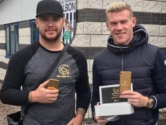 Derry man James McClean (right) pictured receiving his exquisite new iPhone from iDesign Gold at West Bromwich Albion training centre on Tuesday. (Photo: James McClean/Instagram)