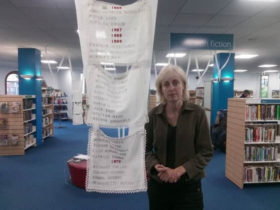 Lycia Trouton with some of the pieces from the Lycia Trouton at the Central Library.