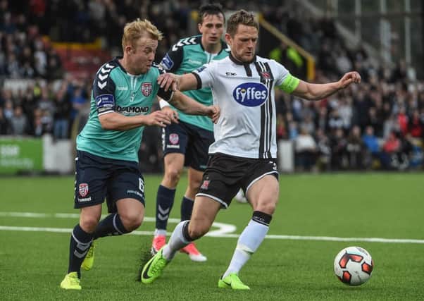 Derry City's Nicky Low tussles with Dundalk defender Dane Massey.