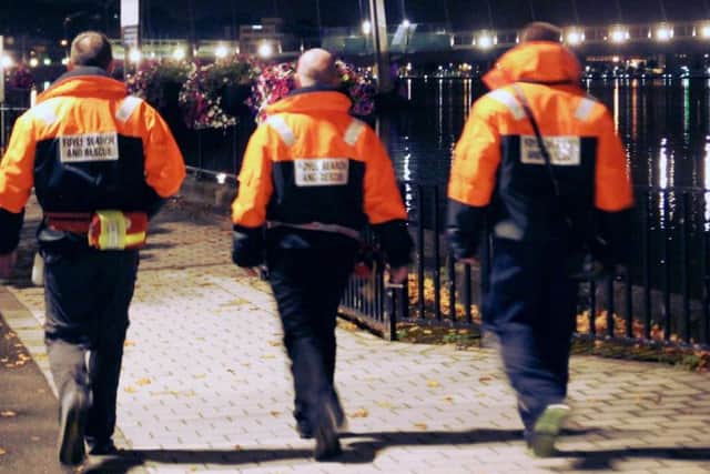 Volunteers from Foyle Search and Rescue patrolling along the river at night.