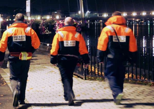 Volunteers from Foyle Search and Rescue patrolling along the river at night.