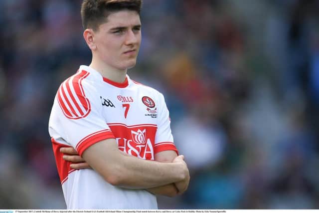 Derry's Conleth McShane looks on dejected as Kerry lift the Tom Markham Cup in Croke Park after the minor final.