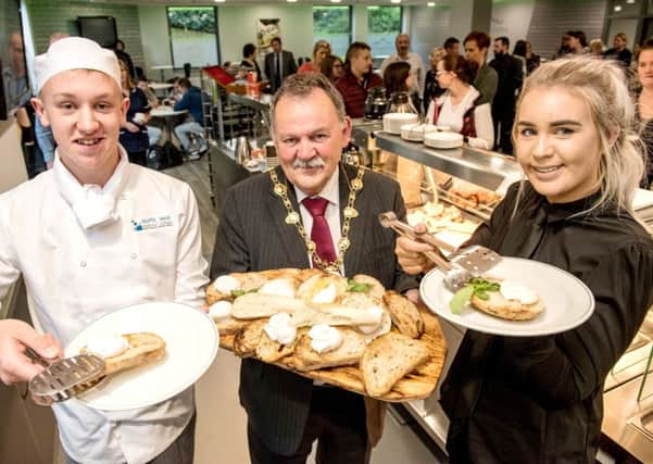 Mayor of Derry and Strabane District Council MaolÃ­osa McHugh serves the first breakfast at North West Regional College's newly refurbished Flying Clipper Brasserie with hospitality and catering students Calum Falls and Siobhan Walton.