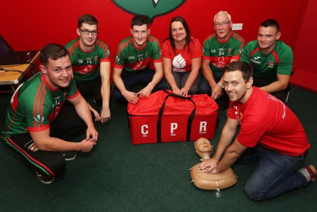 Slaughtmanus GAA members Ronan Cooke, Ryan O'Doherty, Conor Lyons,  Michael McShane and Cathal Deery being trained in CPR by the British Heart Foundations Karen McCammon [centre] and Craig Moore [front right].