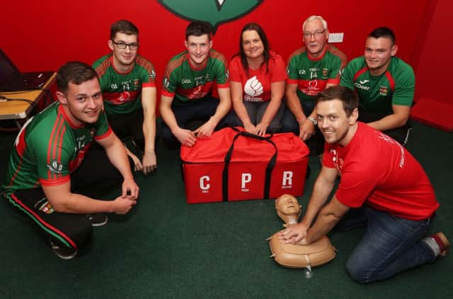 Slaughtmanus GAA members Ronan Cooke, Ryan O'Doherty, Conor Lyons,  Michael McShane and Cathal Deery being trained in CPR by the British Heart Foundations Karen McCammon [centre] and Craig Moore [front right].