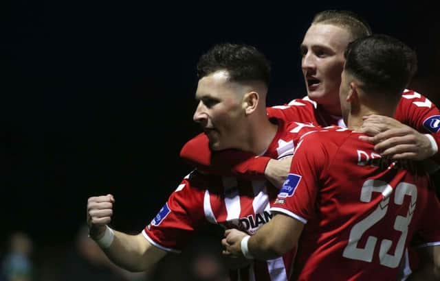 Derry's Conor McDermott celebrates scoring their first goal with Ronan Curtis and Ben Doherty.
 Photograph by INPHO/Lorcan Doherty