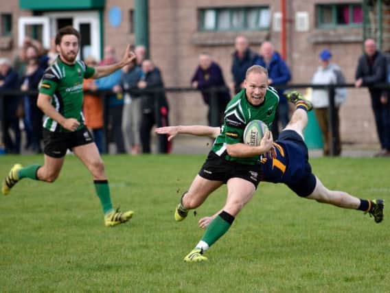 City of Derry centre Paddy Blenerhassett breaks the Skerries defence to score his side's second try at the Craig Thompson Stadium at Judges Road on Saturday.