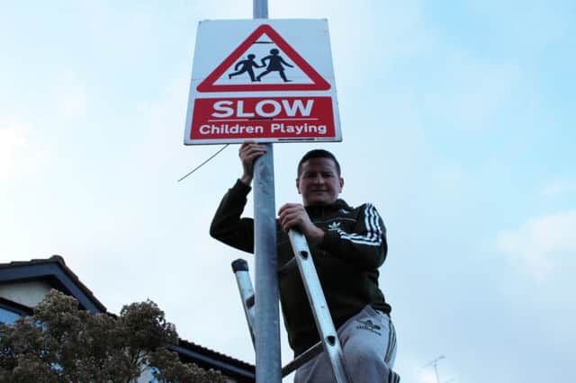 Sinn Fein Councillor Colly Kelly pictured where the signs were erected.