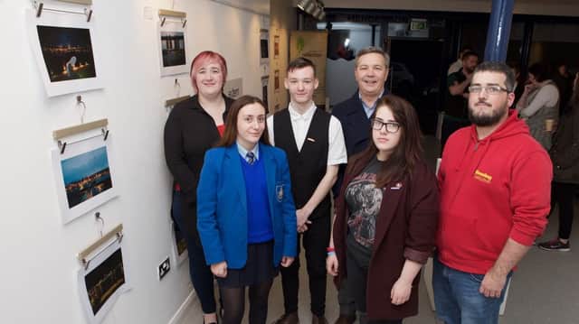 Attending the Everyday Life photo exhibition at the Garden of Reflection Gallery in Derry City were: (far right) Patrick Duddy from the Housing Executive, with budding young photographers from left,  Heather Gillespie, Seamus McGlinchey and Jodie McGlinchey. Also pictured are Emma-Jane Logue (far left) and Paul Sweeney (centre back row) from Extern. (Photo - Tom Heaney, nwpresspics)