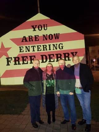 Foyle MLAs Raymond McCartney and Karen mullan with Councillors Eric McGinley and paul Fleming as Free Derry Wall is lit up in the colours of the Catalonian flag on Sunday night.