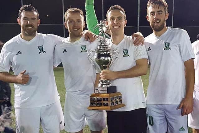 Aaron King, Mark O'Kane, Daniel Gavin and Damien McGee, who played their part in Toronto Harps remarkable unbeaten season, celebrate the recent TSSL Cup success.