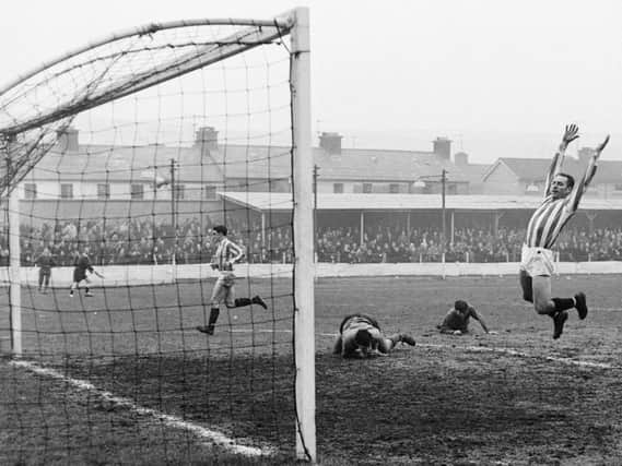 Danny Hale throws his arms in the air as Derry take the lead against Cliftonville in an Irish League clash at Brandywell in 1969.