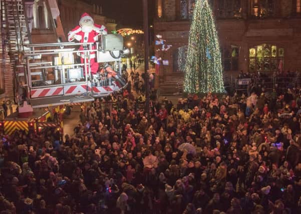 Santa flys over the crowd with the help of the Fire and Rescue Service during a previous Christmas Lights Switch on in Derry. Picture Martin McKeown. Inpresspics.com. 17.11.16